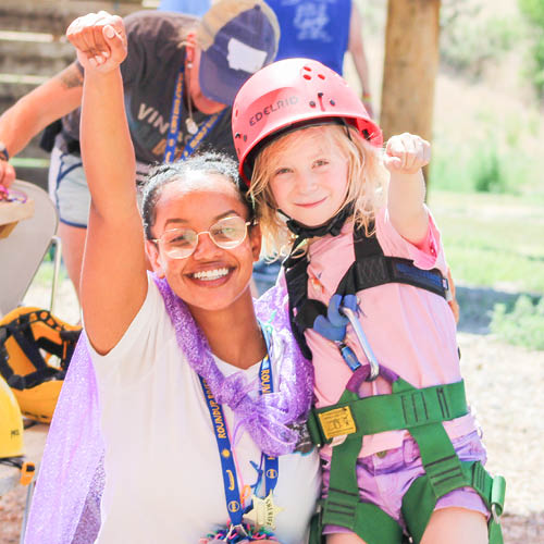 Superhero climbing wall volunteer and camper