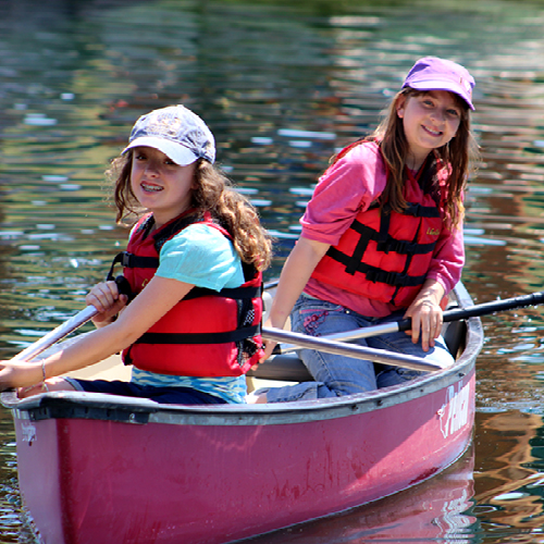 Two campers in canoe in pond