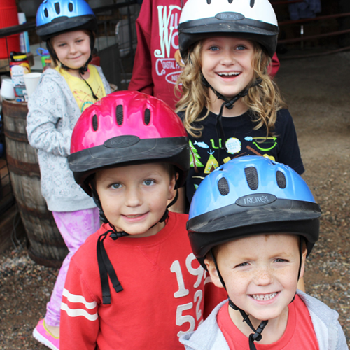 four campers getting ready for equestrian experience
