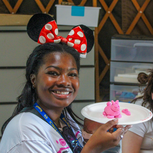Camper with a piece of artwork that she made.