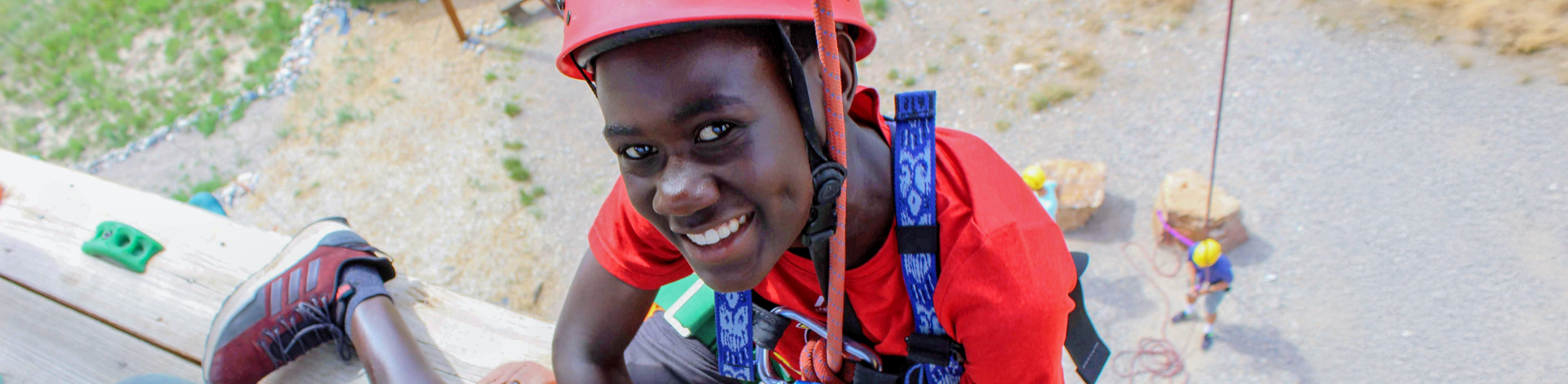 Proud camper reaching the top of the climbing wall.