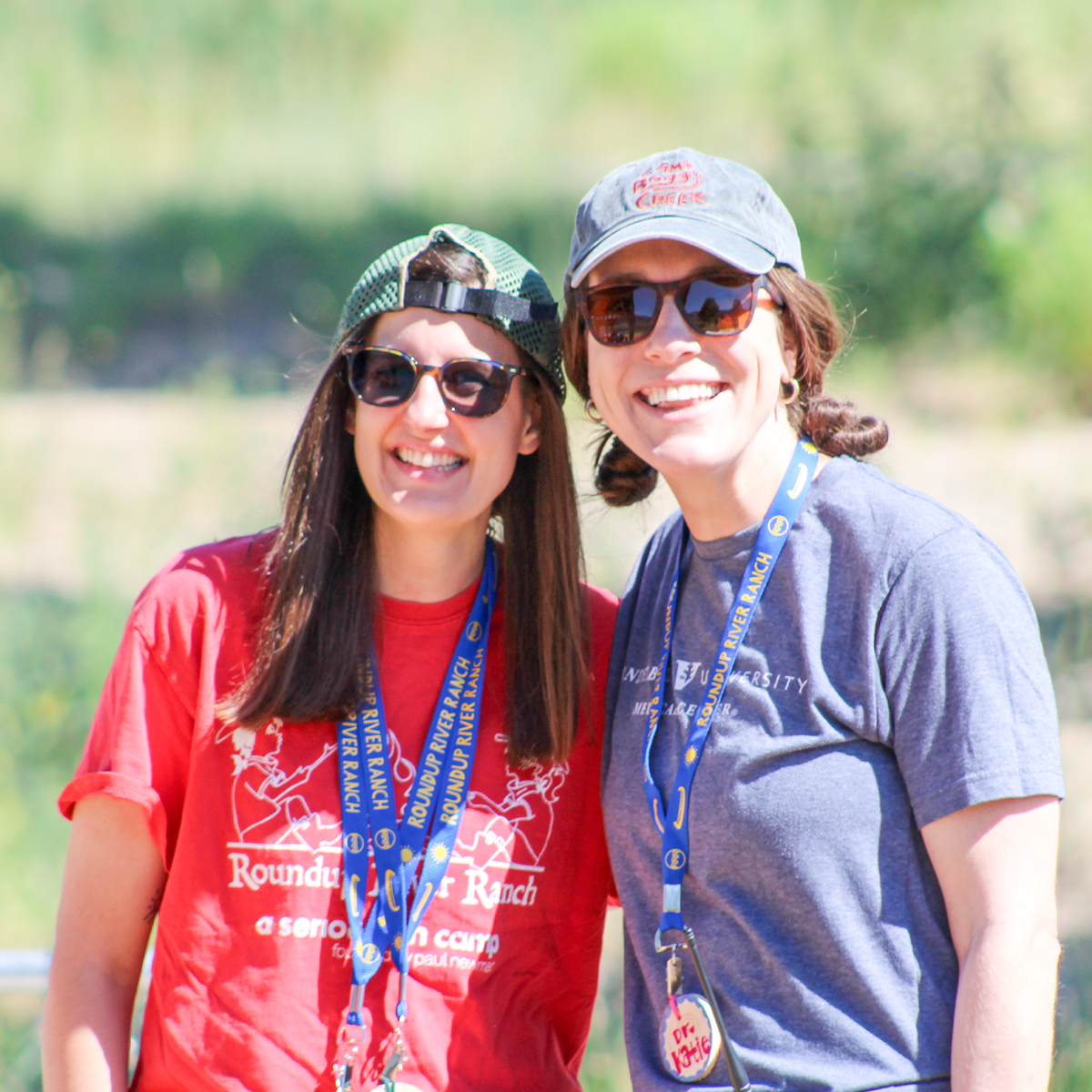 Two female volunteers smiling at camera
