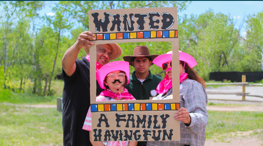 Family within a frame that says "wanted: a family having fun: