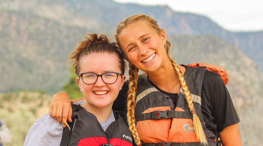 howdy hangout camper and counselor smiling at the camper before rafting