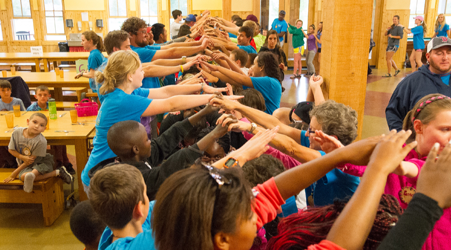 campers making human bridge