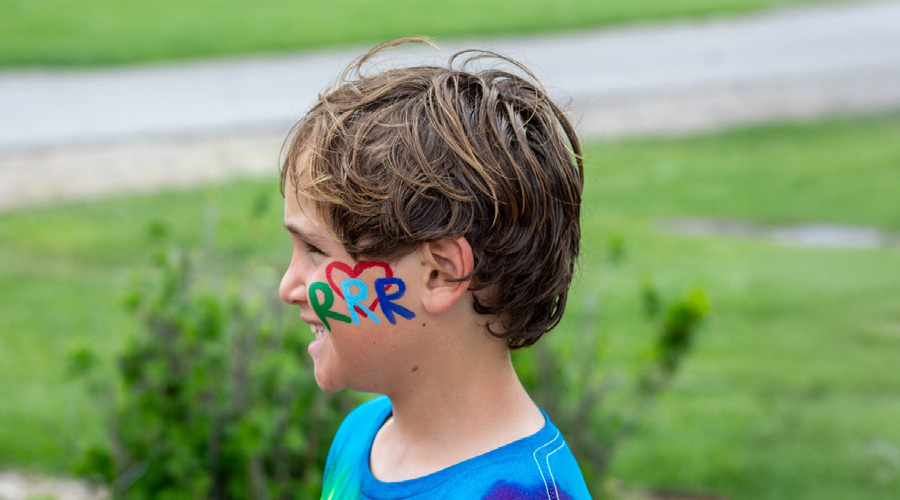 camper with RRR on his face