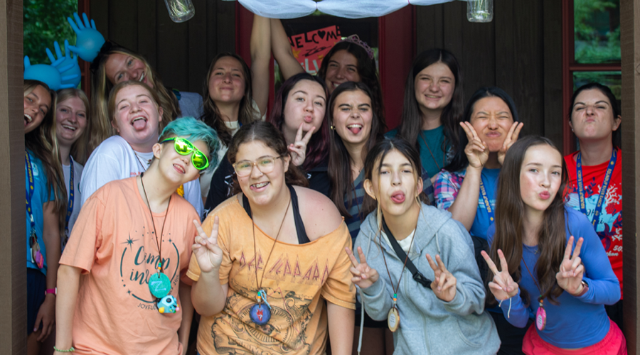 campers in group in front of cabin