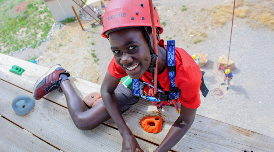Proud camper reaching the top of the climbing wall.