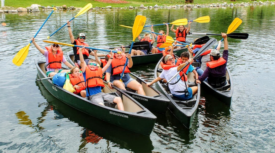 Proud camper reaching the top of the climbing wall.
