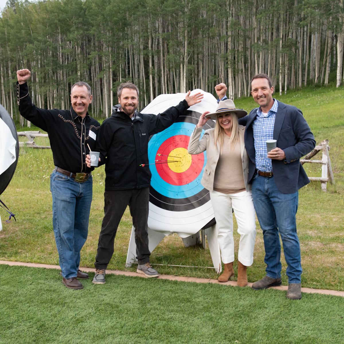 Bullseye Roundup attendees standing in front of archery bullseye. 