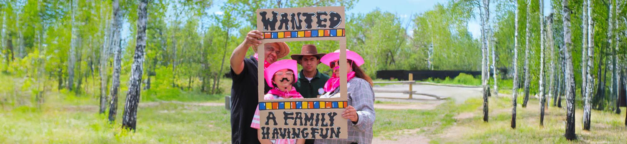 Family within a frame that says "wanted: a family having fun: