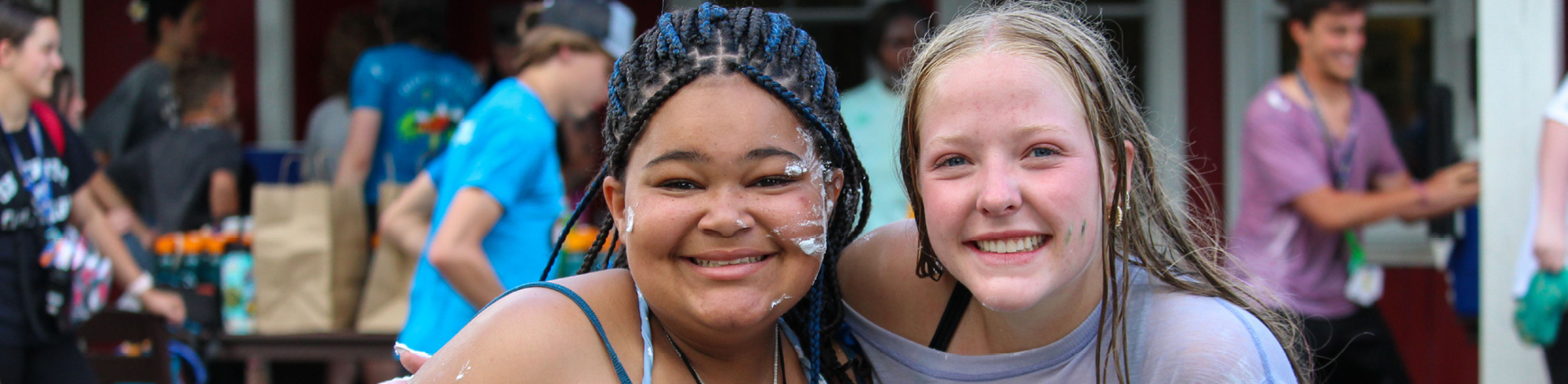 two new camper friends smiling at camera